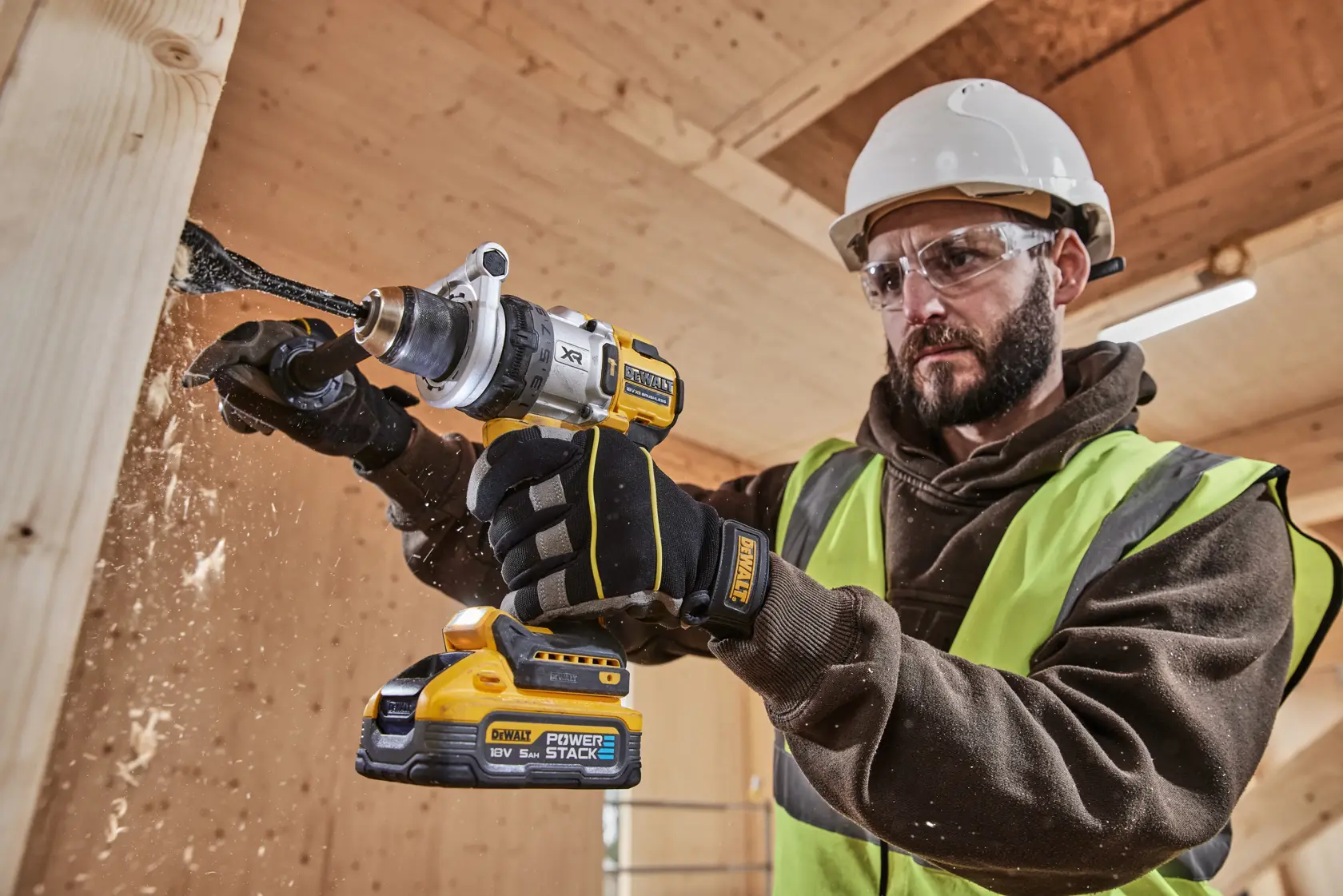DEWALT drill in use, showing DCD1007NT and DCZ607X2-XE SKUs. Worker in safety gear drilling wood.