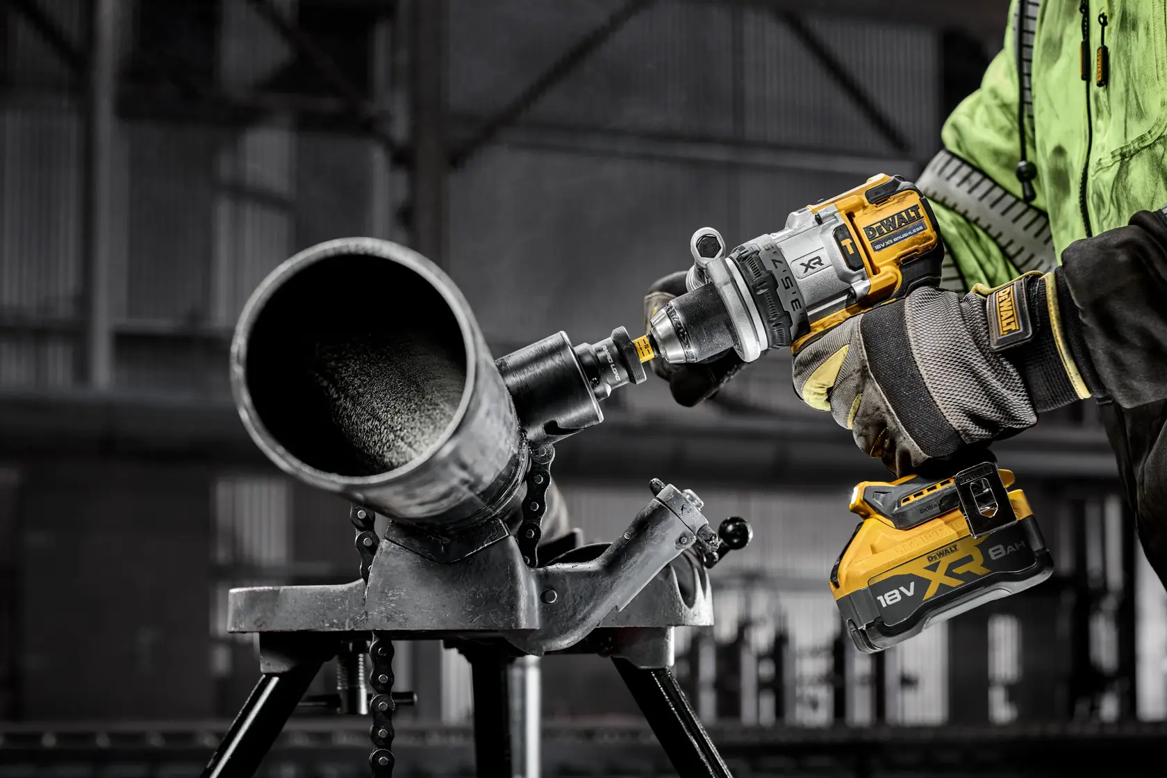 DEWALT DCD1007NT, DCZ607X2-XE drill used on metal pipe in industrial setting. Gloves and battery visible.