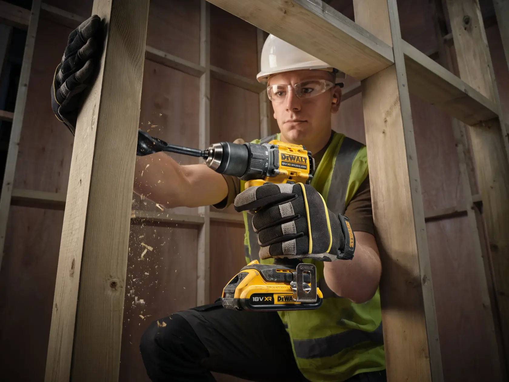 DEWALT DCD794D2T-QW, DCD794D2T drill used on wood by person in gloves and vest. Photography product category.