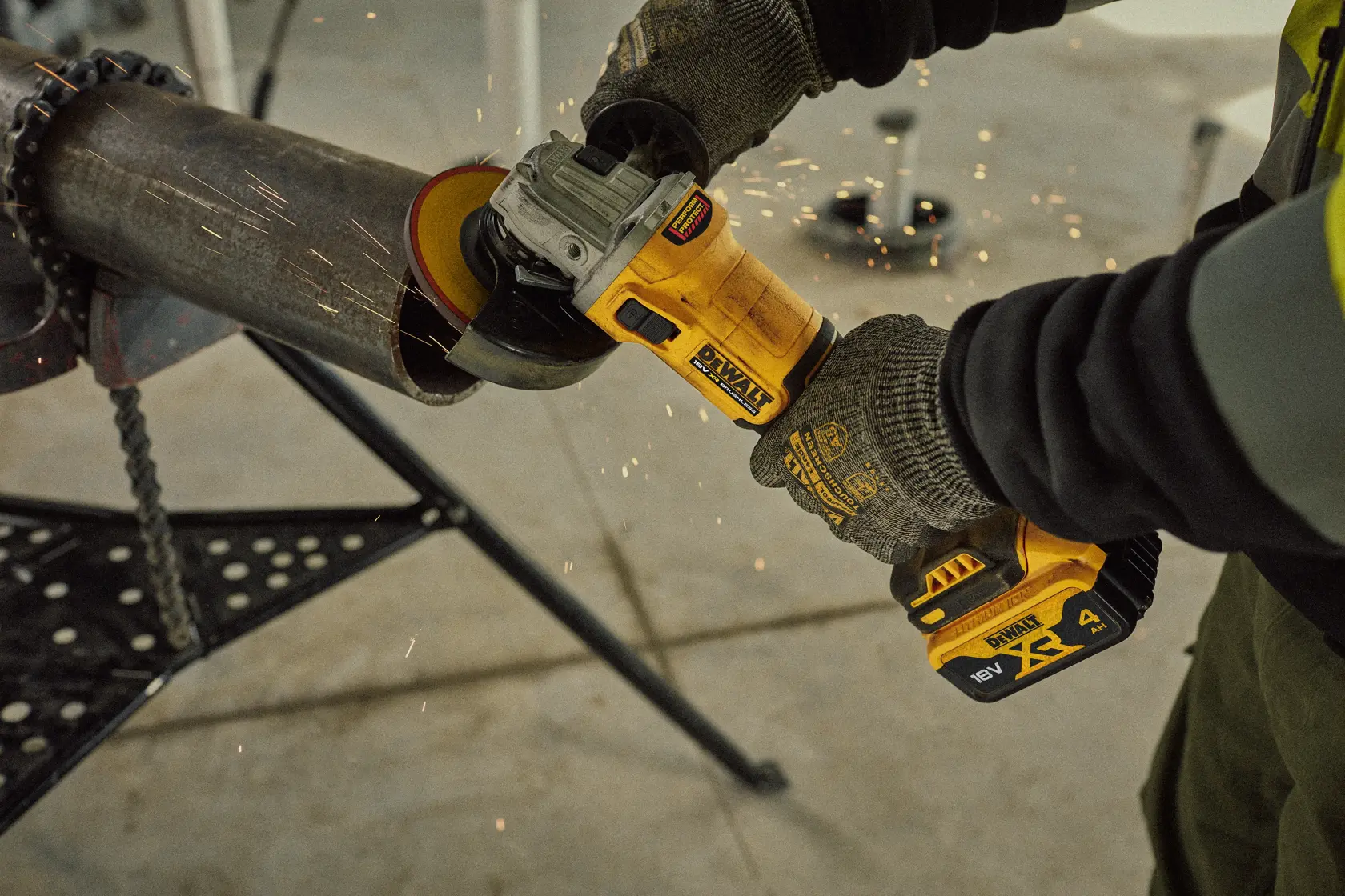 DEWALT grinder in use cutting pipe. Models DCG407M2T, DCG407M2T-QW visible. Sparks fly during operation.