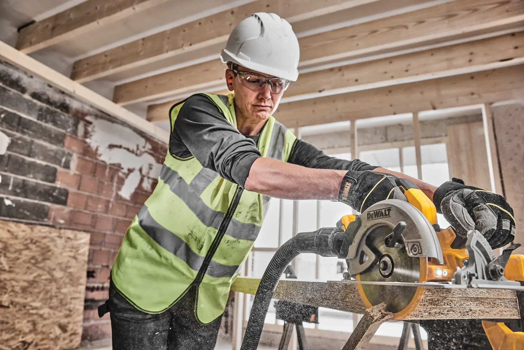 A DEWALT cordless circular saw kit is shown, including a yellow and black circular saw, two battery packs, a battery charger, and a sturdy black carrying case.