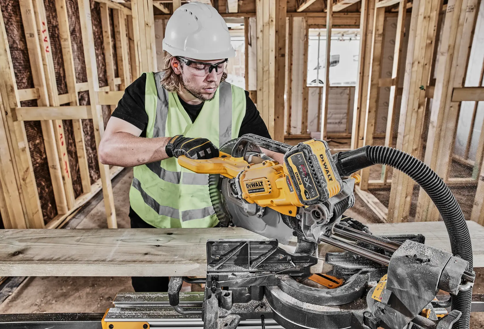 DEWALT DCS781X2-QW, DCS781X2 saw in use on construction site, worker cutting wood. Photography category.