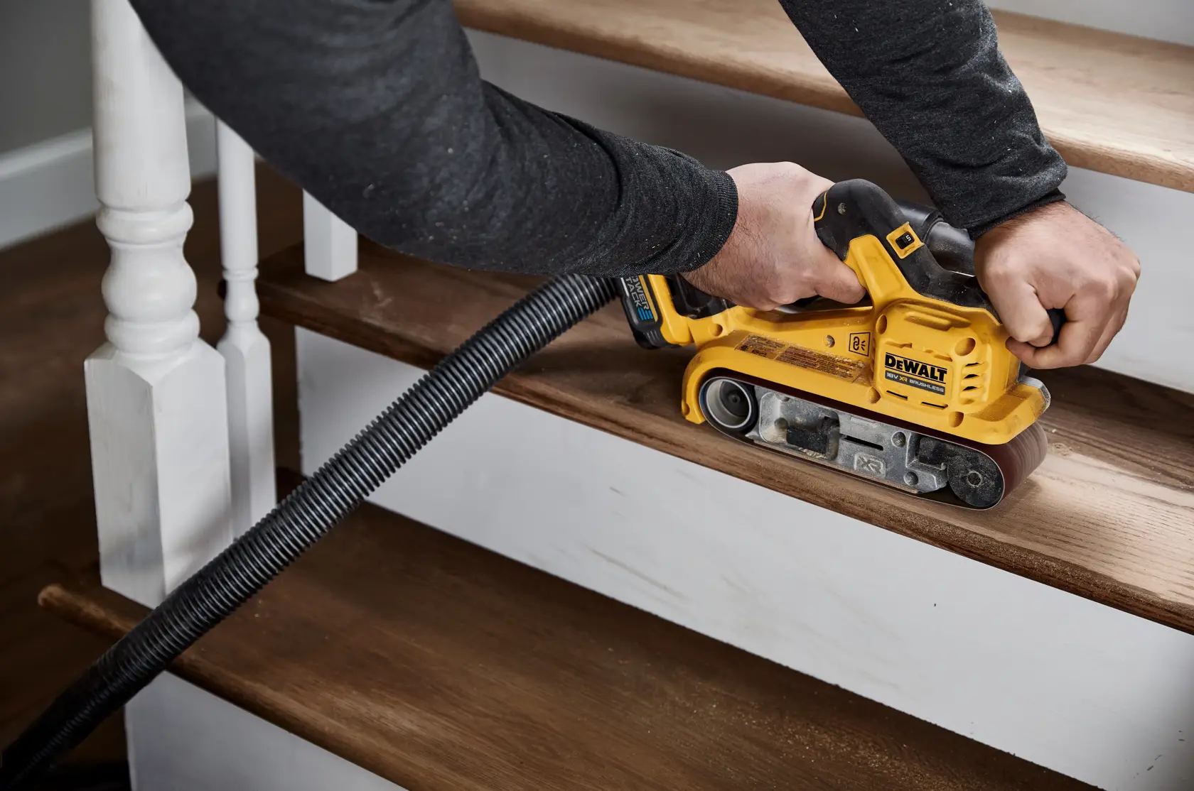 DEWALT cordless belt sander with black and yellow design, ergonomic handle and brushless motor.