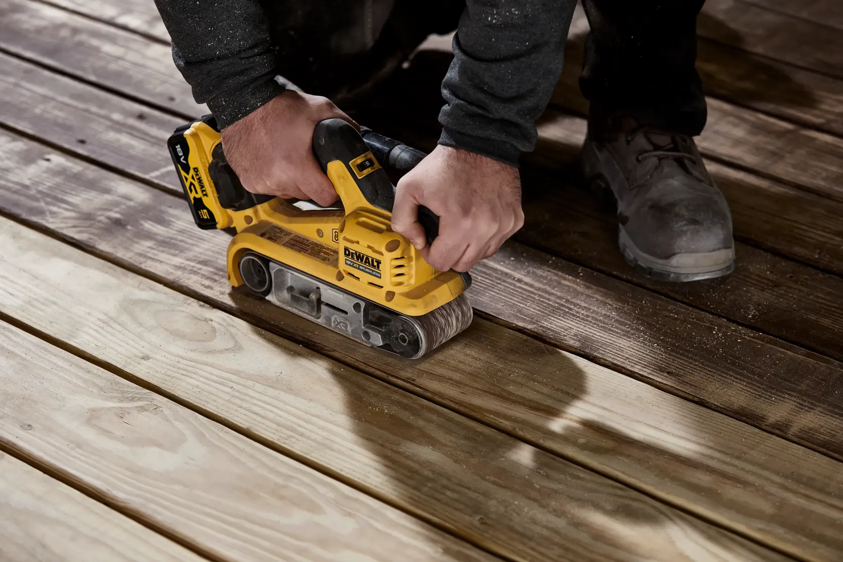 DEWALT DCW220P2 cordless belt sander with brushless motor and 18V XR battery, yellow and black design.