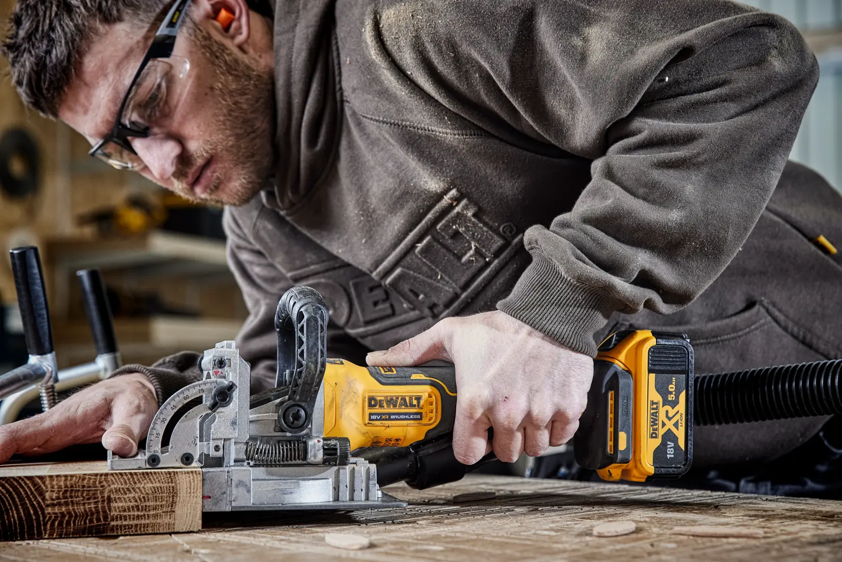 DEWALT tool in use for woodworking. Photography category. SKUs: DCW682P2-QW, DCW682P2.