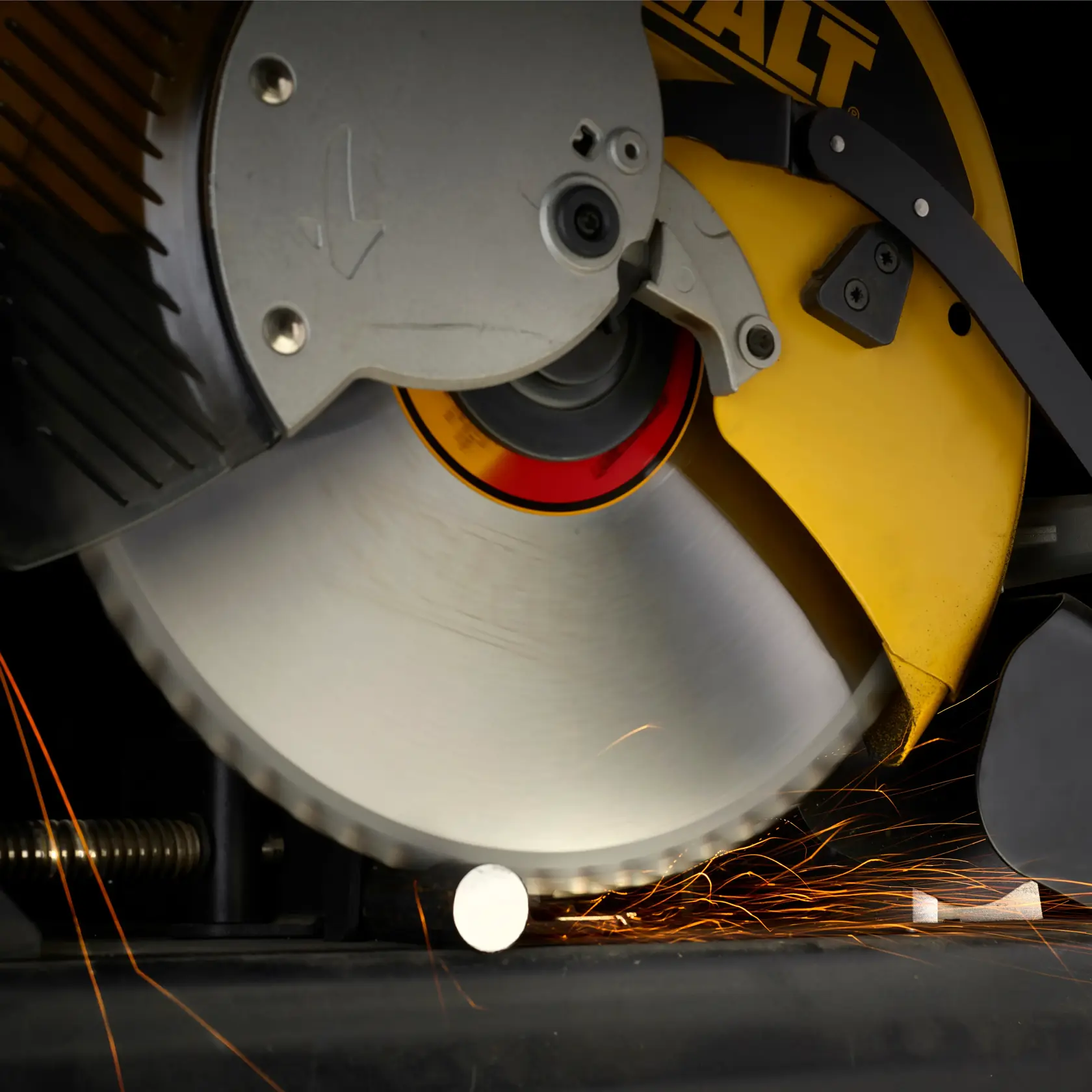 DEWALT circular saw cutting metal, sparks flying as the blade slices through a metal rod.