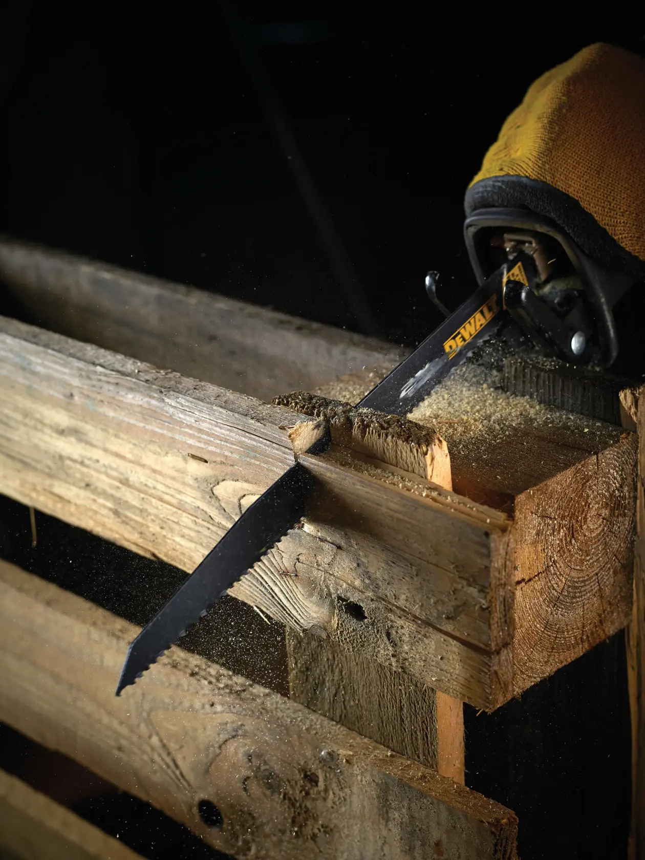 DEWALT saw blade cuts through wooden pallet, creating sawdust during woodworking.