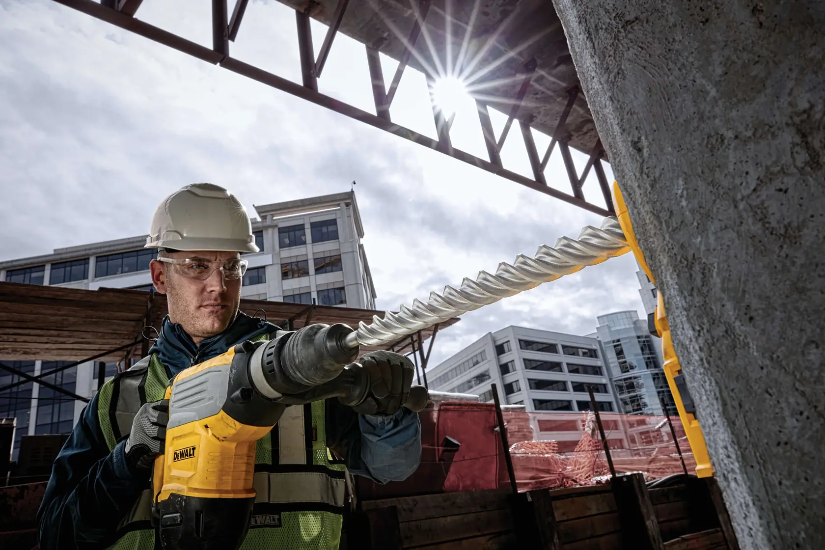 DEWALT drill with attachment used for concrete surface drilling, showing dust extraction component.