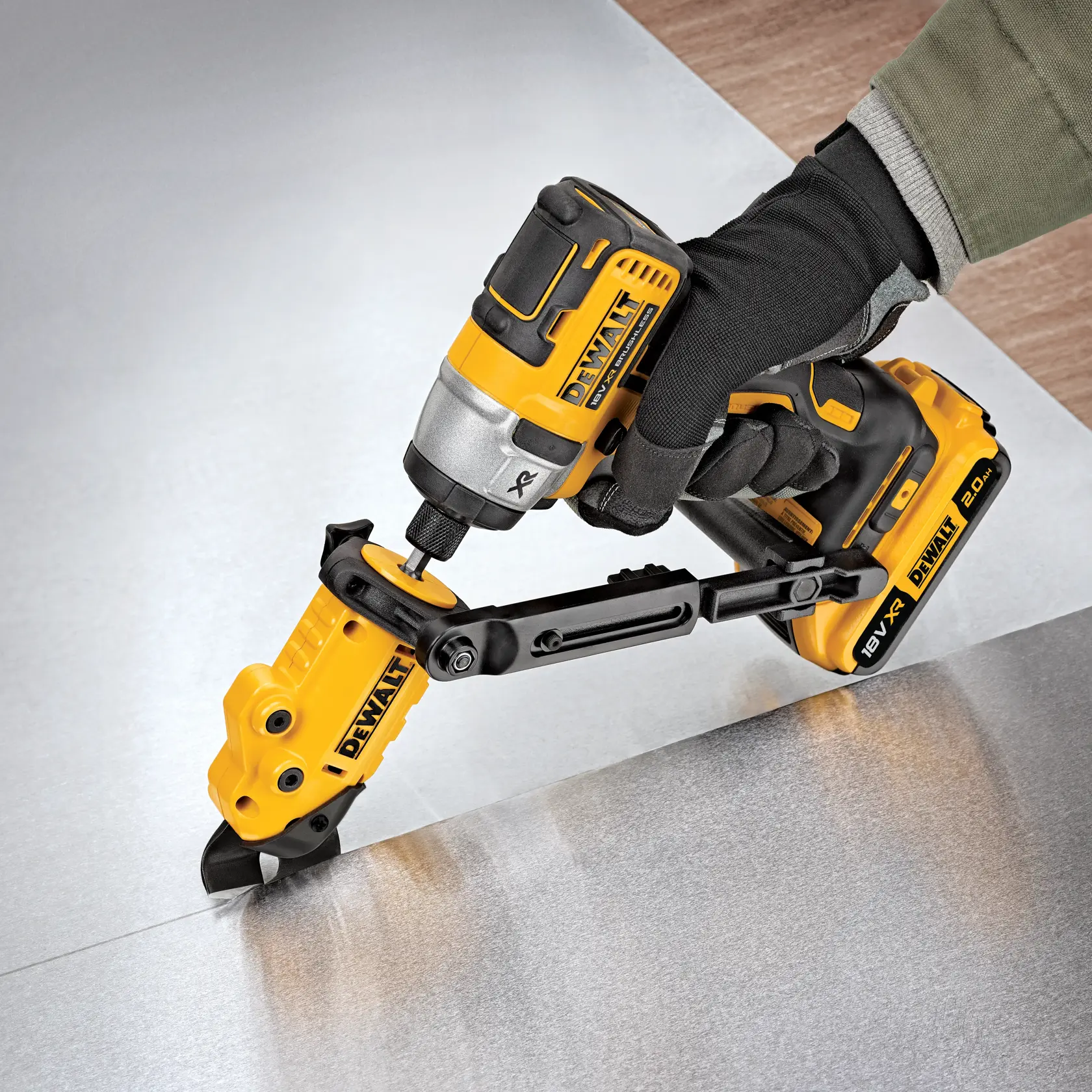 DEWALT power tool with attachment cutting sheet metal, operated by a gloved hand.