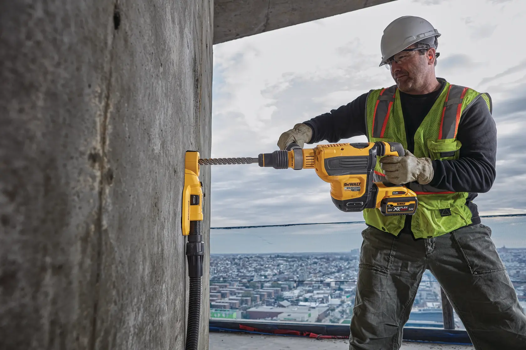DEWALT DWH050, DWH050K, DWH050-XJ dust extractor used on concrete wall at construction site.