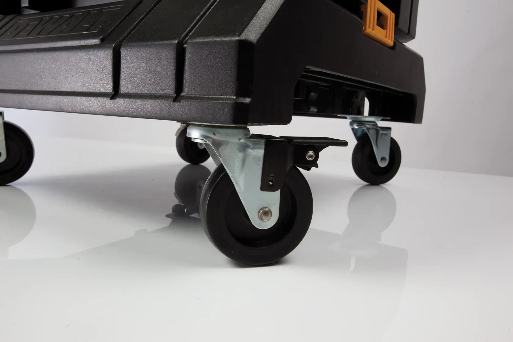 Close-up of DEWALT mobile toolbox wheels, showing the sturdy black plastic and metal casters for easy transport.