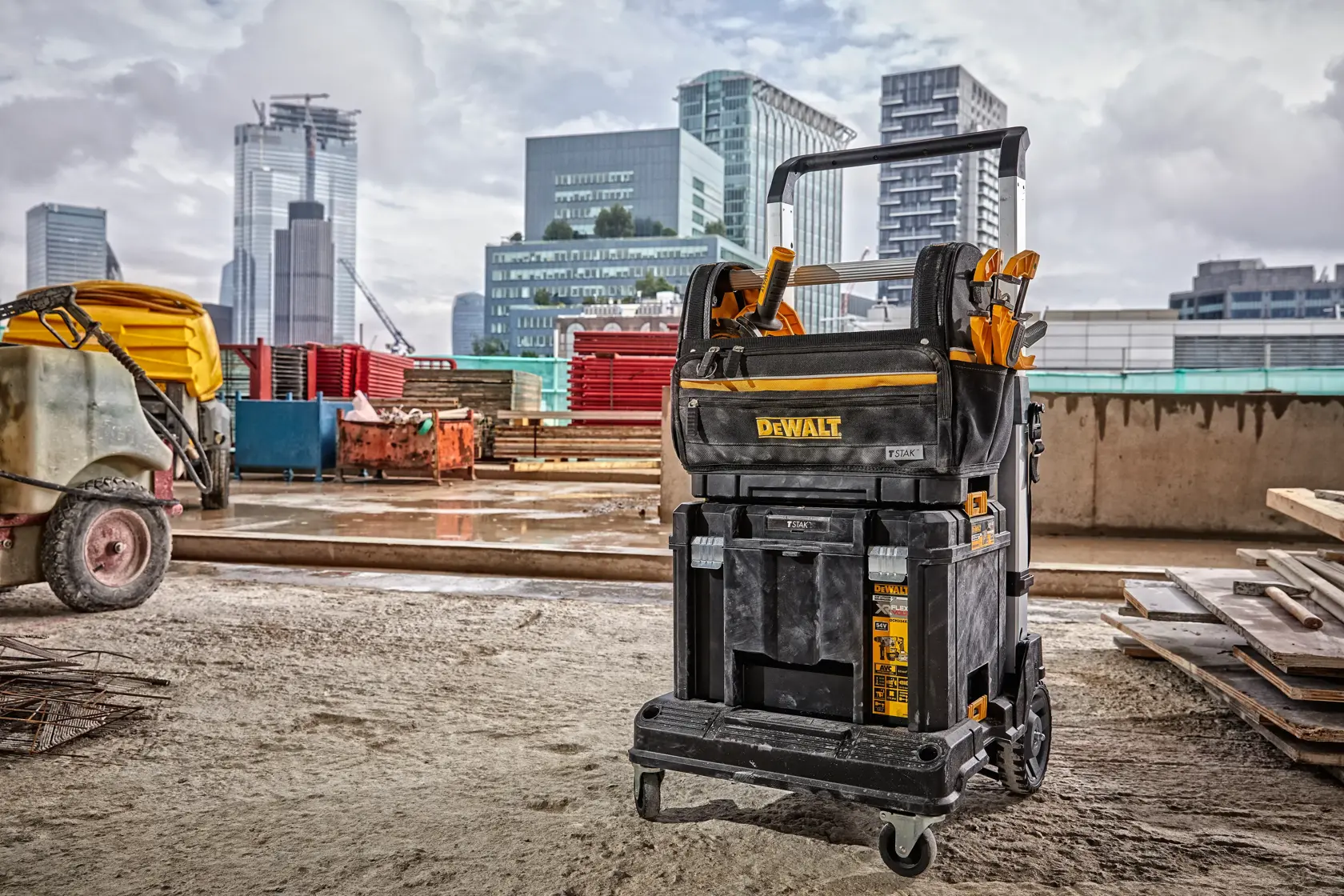 DEWALT mobile tool storage cart on a construction site with city buildings in the background.