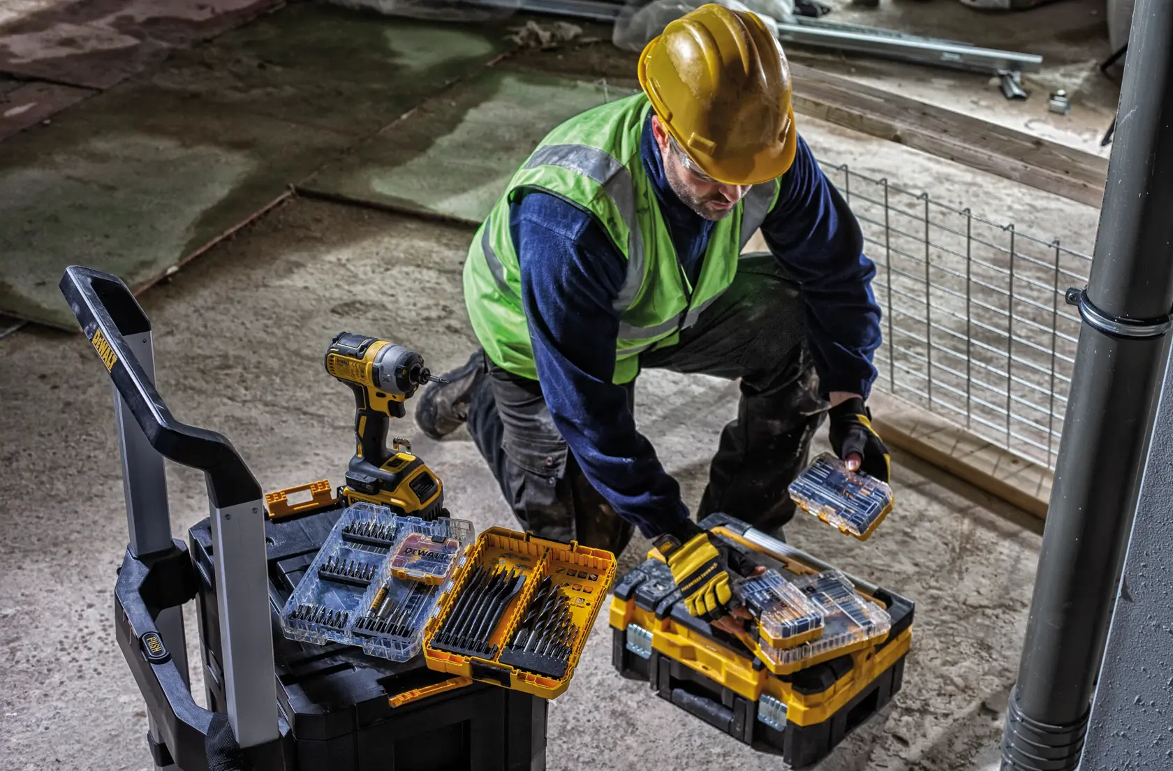 DEWALT DWST83454-1, DWST1-71196, DT70758 tool sets on site, worker handling cases. Photography category.